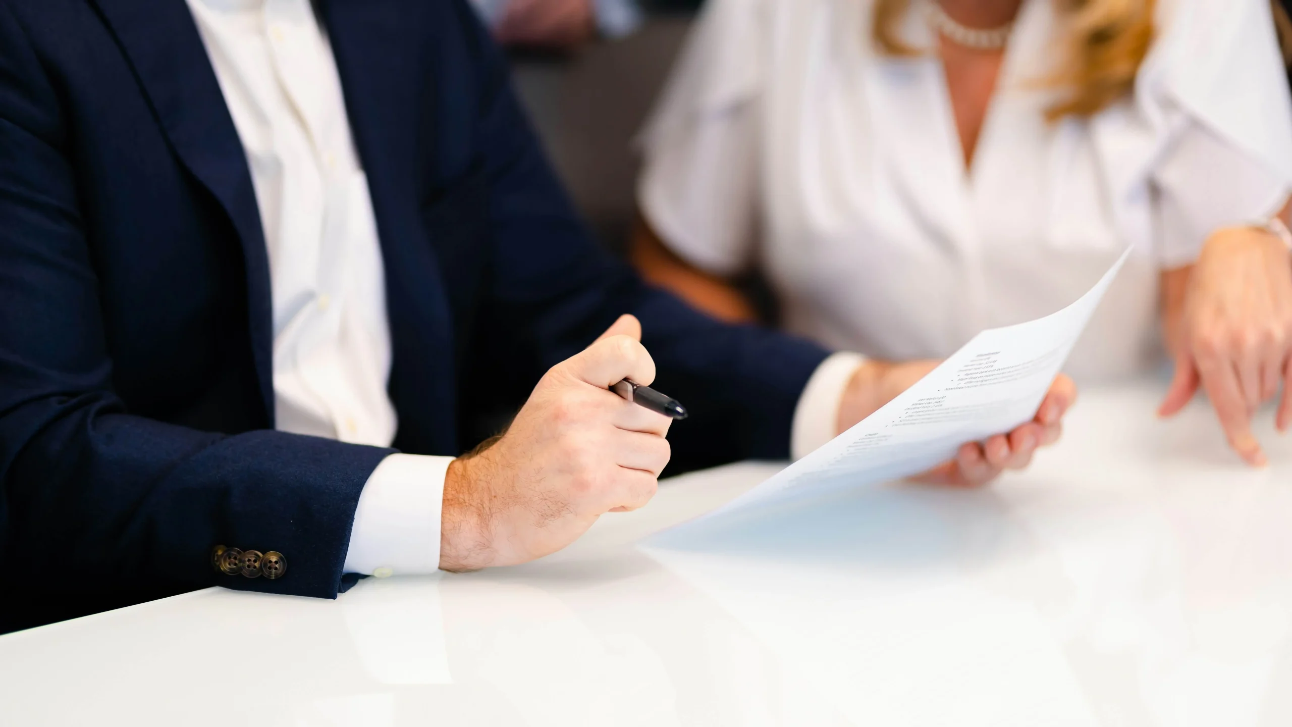 two people having a conversation over a document oil and gas consulting firmnavigator petroleum